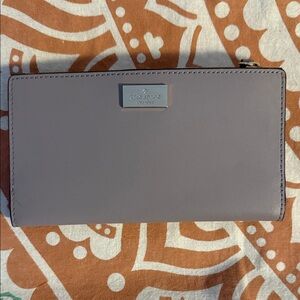 kate spade lilac zip-around wallet with metal logo